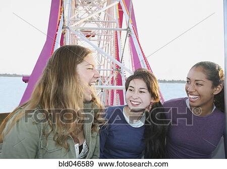 Multi-ethnic girls on Ferris wheel View Large Photo Image Stock Photo - Multi-ethnic girls on Ferris wheel. Fotosearch