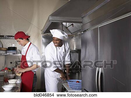 Picture - Multi-ethnic male chefs preparing food. Fotosearch