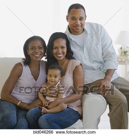 Stock Photograph - Multi-generational African American family on sofa. Fotosearch