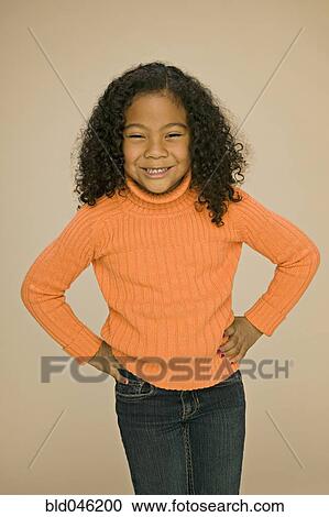 Stock Image - Pacific Islander girl with hands on hips. Fotosearch