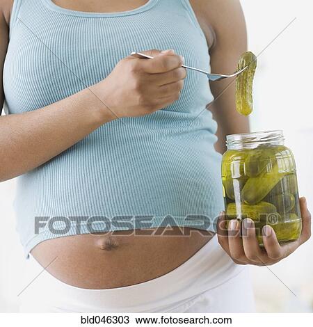 Pregnant African American woman holding pickles View Large Photo Image Stock Image - Pregnant African American woman holding pickles. Fotosearch