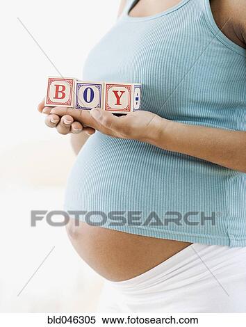 Pregnant African American woman holding “BOY” blocks View Large Photo Image Stock Photography - Pregnant African American woman holding “BOY” blocks. Fotosearch