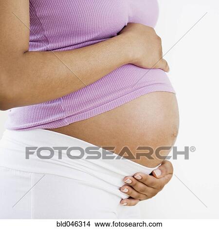 Pregnant African American woman with hands on belly View Large Photo Image Picture - Pregnant African American woman with hands on belly. Fotosearch