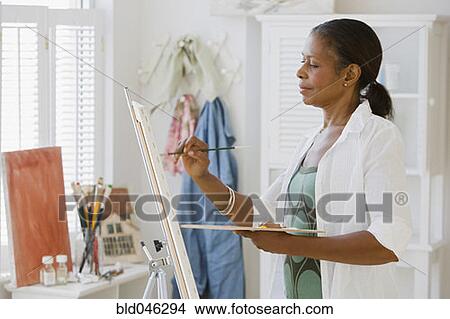Picture - Senior African American woman painting. Fotosearch