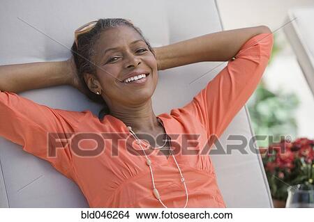 Senior African American woman with hands behind head View Large Photo Image Picture - Senior African American woman with hands behind head. Fotosearch