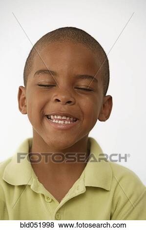 Stock Photo - African American boy with eyes closed. Fotosearch