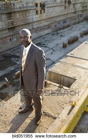 Stock Photography - African American businessman at dry dock. Fotosearch