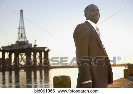 Stock Photograph - African American businessman on commercial pier. Fotosearch