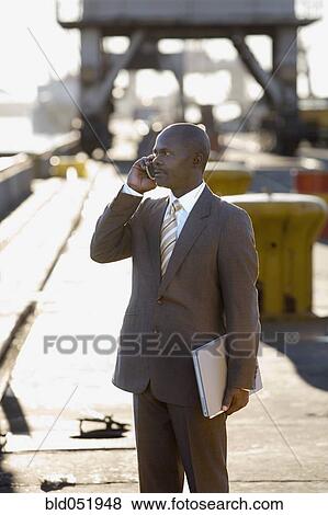 Stock Photo - African American businessman talking on cell phone. Fotosearch