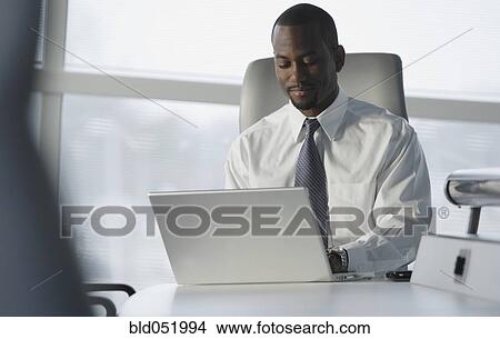African American businessman typing on laptop View Large Photo Image Picture - African American businessman typing on laptop. Fotosearch