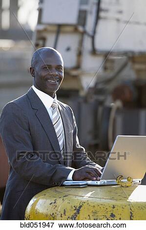 Stock Photo - African American businessman typing on laptop. Fotosearch