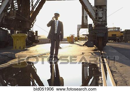 Stock Photograph - African American businessman wearing hardhat. Fotosearch