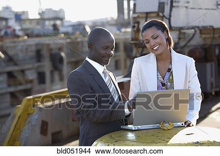 African American businesspeople looking at laptop View Large Photo Image Picture - African American businesspeople looking at laptop. Fotosearch
