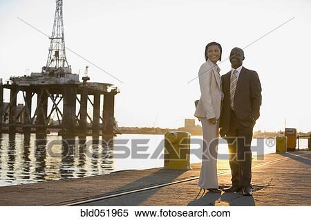 Stock Photography - African American businesspeople on commercial pier. Fotosearch