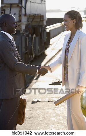 African American businesspeople shaking hands View Large Photo Image Stock Image - African American businesspeople shaking hands. Fotosearch