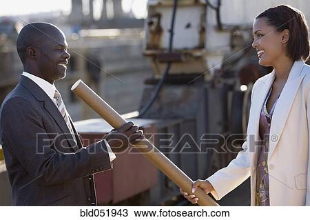 African American businesspeople exchanging blueprints View Large Photo Image Stock Image - African American businesspeople exchanging blueprints. Fotosearch
