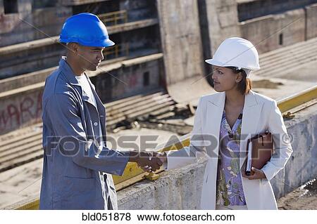 African American businesswoman and construction worker shaking hands View Large Photo Image Stock Photo - African American businesswoman and construction worker shaking hands. Fotosearch