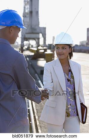 African American businesswoman and construction worker shaking hands View Large Photo Image Stock Photo - African American businesswoman and construction worker shaking hands. Fotosearch