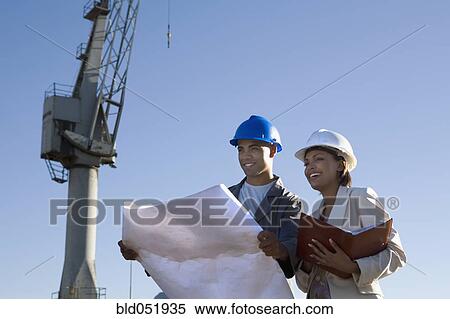 African American businesswoman and construction worker with blueprints View Large Photo Image Stock Photography - African American businesswoman and construction worker with blueprints. Fotosearch