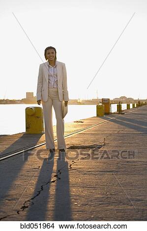African American businesswoman on commercial pier View Large Photo Image Picture - African American businesswoman on commercial pier. Fotosearch