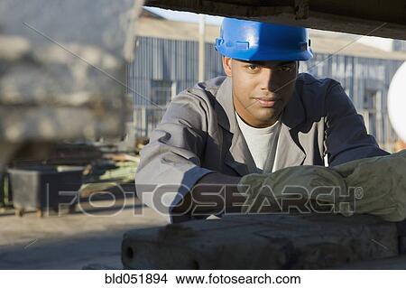 Picture - African American male construction worker wearing hardhat. Fotosearch