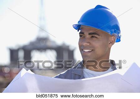 African American male construction worker holding blueprints View Large Photo Image Stock Photography - African American male construction worker holding blueprints. Fotosearch