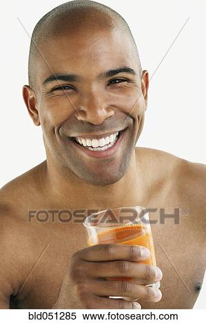 Stock Photography - African American man drinking juice. Fotosearch