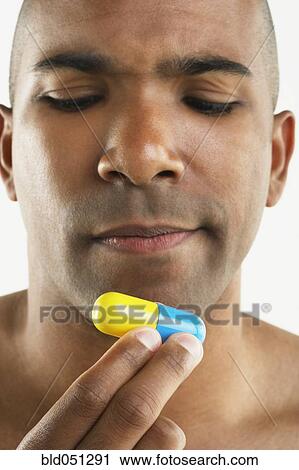 African American man holding big vitamin View Large Photo Image Stock Image - African American man holding big vitamin. Fotosearch