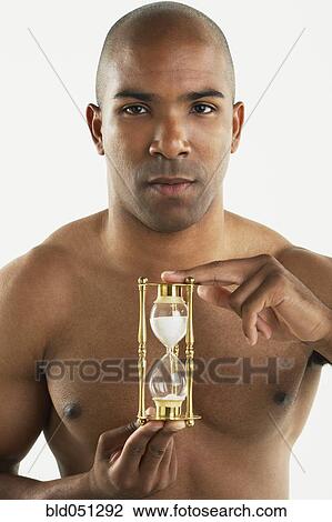 African American man holding hourglass View Large Photo Image Stock Image - African American man holding hourglass. Fotosearch