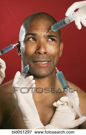 African American man receiving injections in face View Large Photo Image Stock Photo - African American man receiving injections in face. Fotosearch