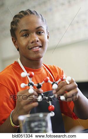 Picture - African American teenaged boy in science class. Fotosearch