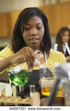 Stock Image - African American teenaged girl in science class. Fotosearch