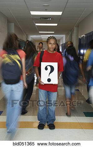 Stock Photography - African American teenaged student holding question mark sign. Fotosearch