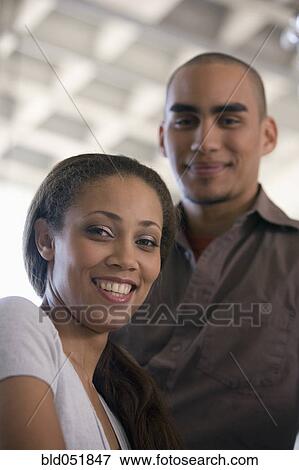 African American woman with boyfriend in background View Large Photo Image Stock Photo - African American woman with boyfriend in background. Fotosearch