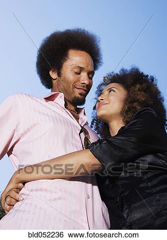 Stock Photograph - African couple hugging. Fotosearch