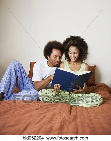 African couple reading in bed View Large Photo Image Picture - African couple reading in bed. Fotosearch