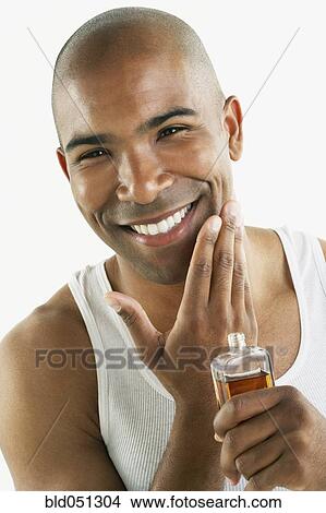 African man applying cologne View Large Photo Image Picture - African man applying cologne. Fotosearch