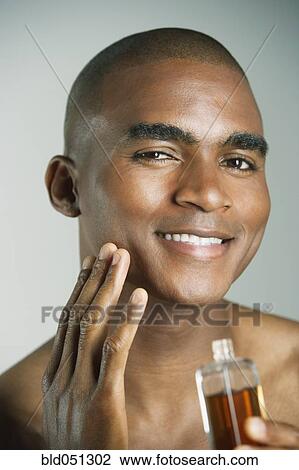 African man applying cologne View Large Photo Image Stock Image - African man applying cologne. Fotosearch