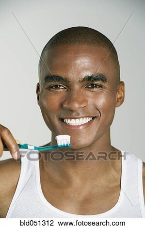 Stock Image - African man brushing teeth. Fotosearch