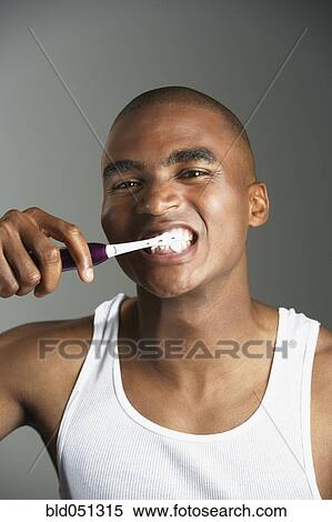Stock Photography - African man brushing teeth. Fotosearch