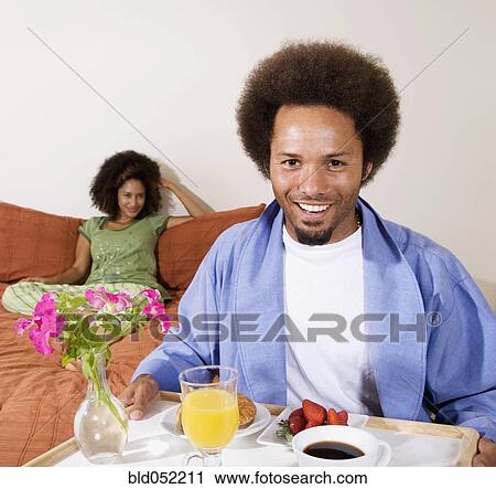 African man carrying breakfast in bed tray View Large Photo Image Stock Image - African man carrying breakfast in bed tray. Fotosearch
