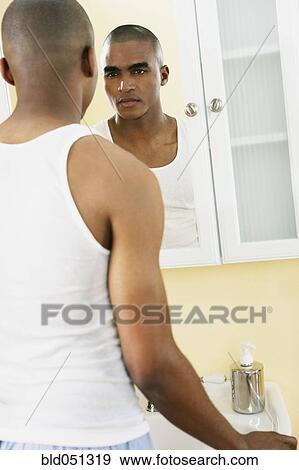 African man looking in mirror View Large Photo Image Stock Photo - African man looking in mirror. Fotosearch