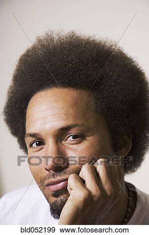 African man resting chin on hand View Large Photo Image Stock Photo - African man resting chin on hand. Fotosearch