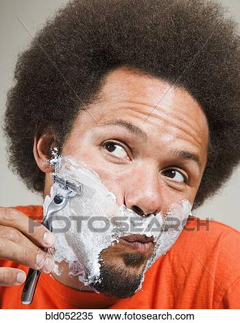 African man shaving face View Large Photo Image Stock Photography - African man shaving face. Fotosearch