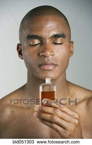African man smelling cologne View Large Photo Image Stock Image - African man smelling cologne. Fotosearch