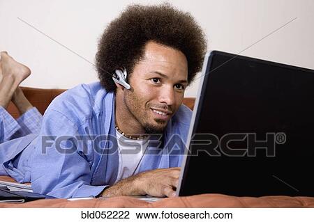 African man typing on laptop View Large Photo Image Stock Image - African man typing on laptop. Fotosearch