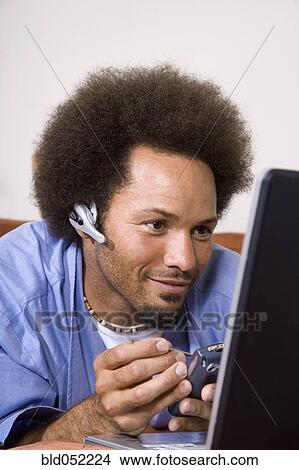 African man using electronic organizer View Large Photo Image Picture - African man using electronic organizer. Fotosearch