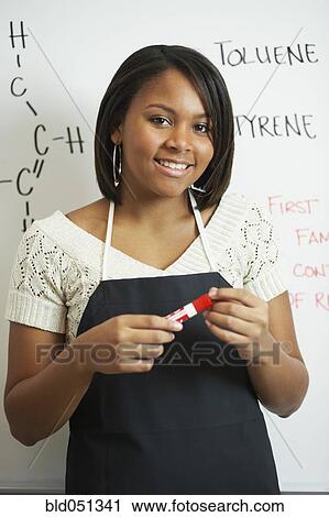 Stock Image - African teenaged girl in science class. Fotosearch