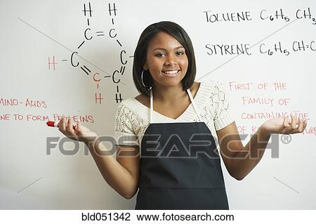Stock Image - African teenaged girl in science class. Fotosearch