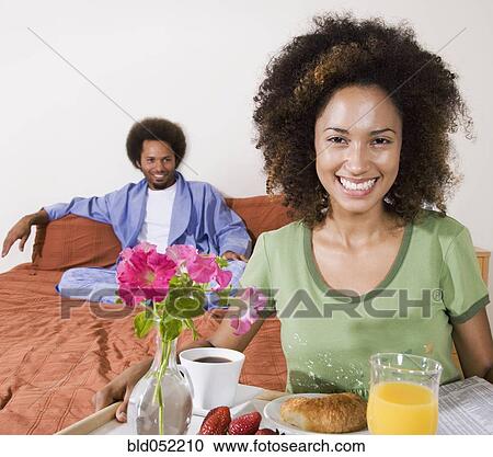 African woman carrying breakfast in bed tray View Large Photo Image Stock Image - African woman carrying breakfast in bed tray. Fotosearch